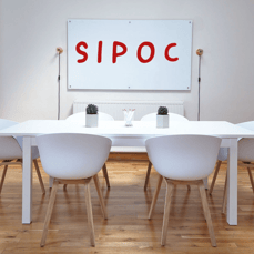 meeting room with chairs in front of a whiteboard with SIPOC method